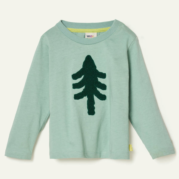 Child wearing the Mon Coeur Snowy Pine long-sleeve T-shirt with boucle embroidered pine tree detail, front view