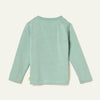 Side view of a child in the Mon Coeur Snowy Pine unisex long-sleeve tee made from recycled and organic cotton