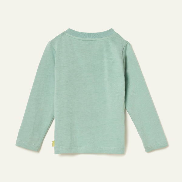 Side view of a child in the Mon Coeur Snowy Pine unisex long-sleeve tee made from recycled and organic cotton