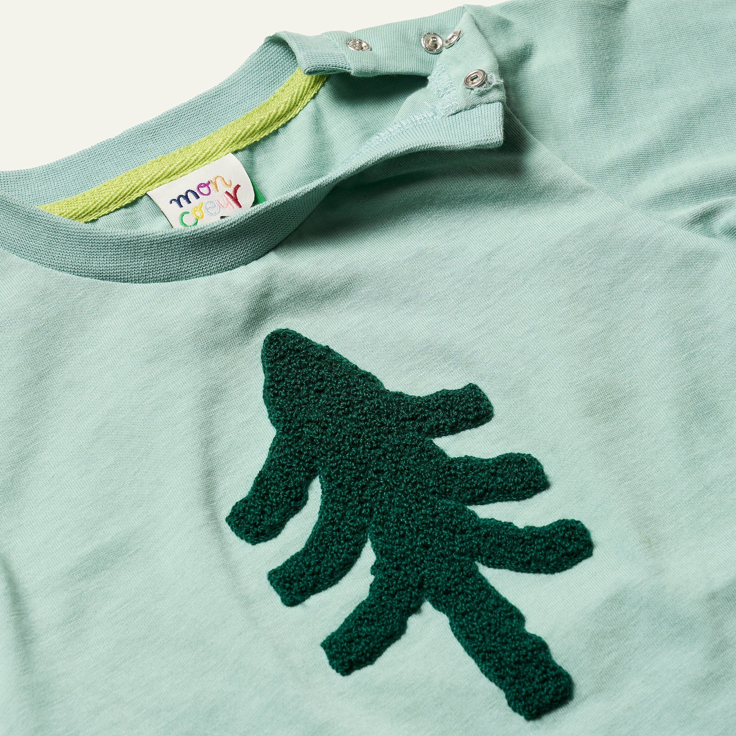 Close-up of the boucle embroidered pine tree on the Mon Coeur Snowy Pine recycled cotton T-shirt