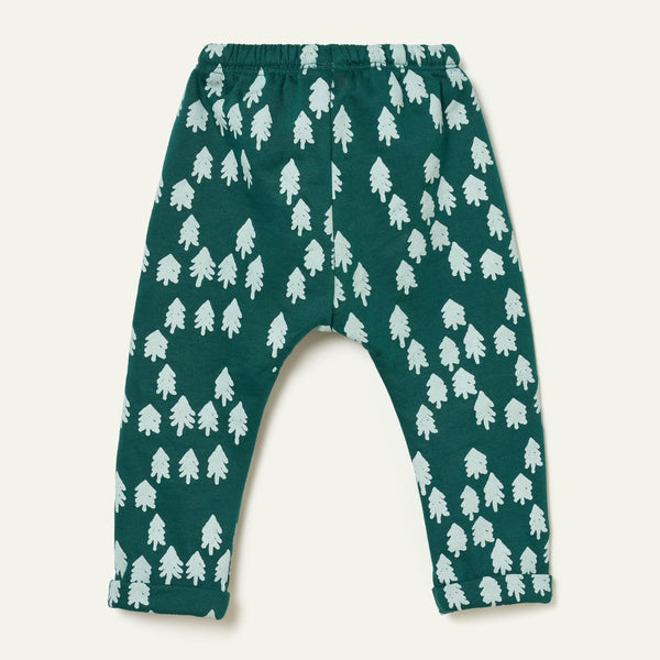 Close-up of the snowy pine tree print on Mon Coeur's forest green recycled cotton kids jogger