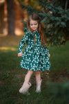 Mon Coeur Snowy Pine Ruffle Dress laid flat, showing full print and A-line silhouette