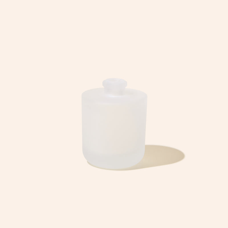 Close-up of 8oz Aura® diffuser bottle showing premium finish and sleek silhouette