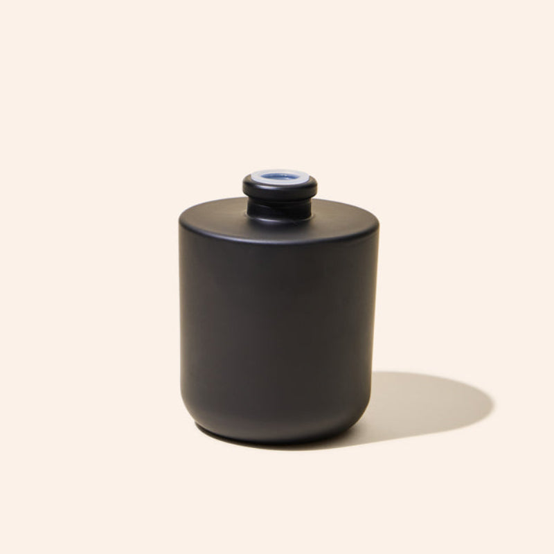 8oz Aura® diffuser bottle alongside matching Aura® candle vessel for a unified product display