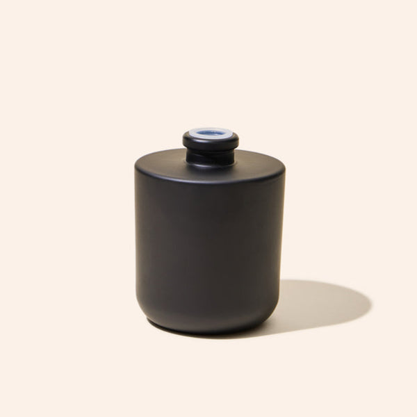8oz Aura® diffuser bottle alongside matching Aura® candle vessel for a unified product display