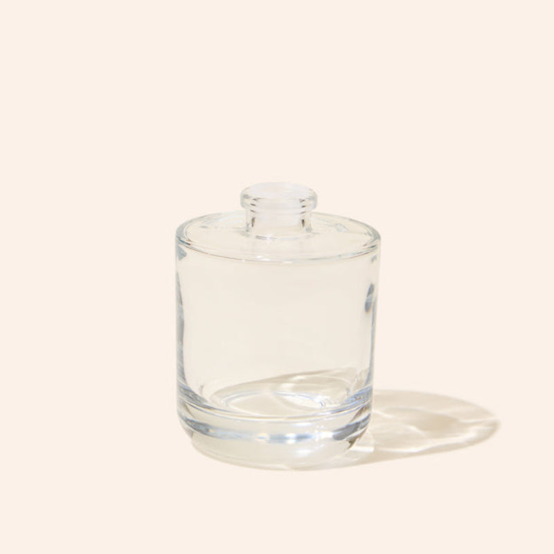 Clear glass tumbler with lid on a white background