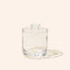 Clear glass tumbler with lid on a white background