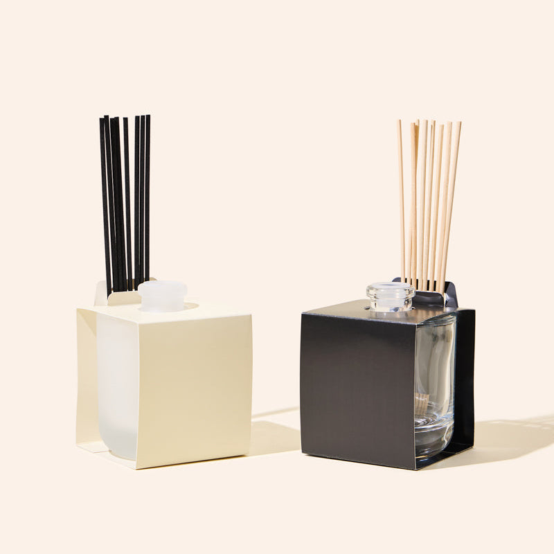 8oz Aura® diffuser wrap and reed holder fitted around a diffuser bottle with rattan reeds