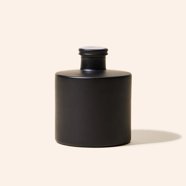 Dream Diffuser Bottle styled on a tabletop as part of a home fragrance display