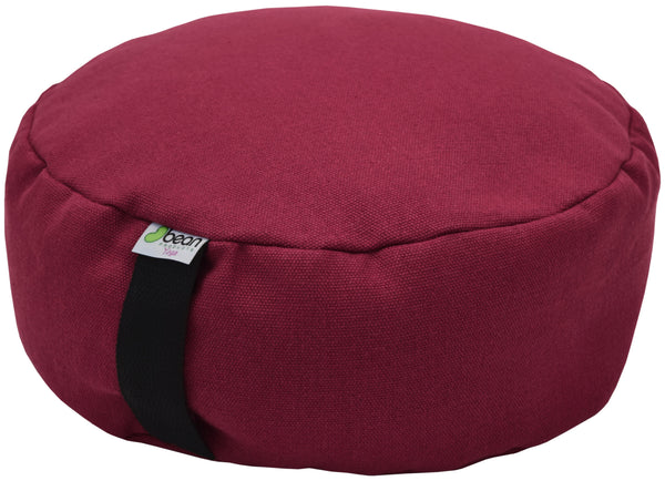 Red meditation cushion with a brand label on a white background