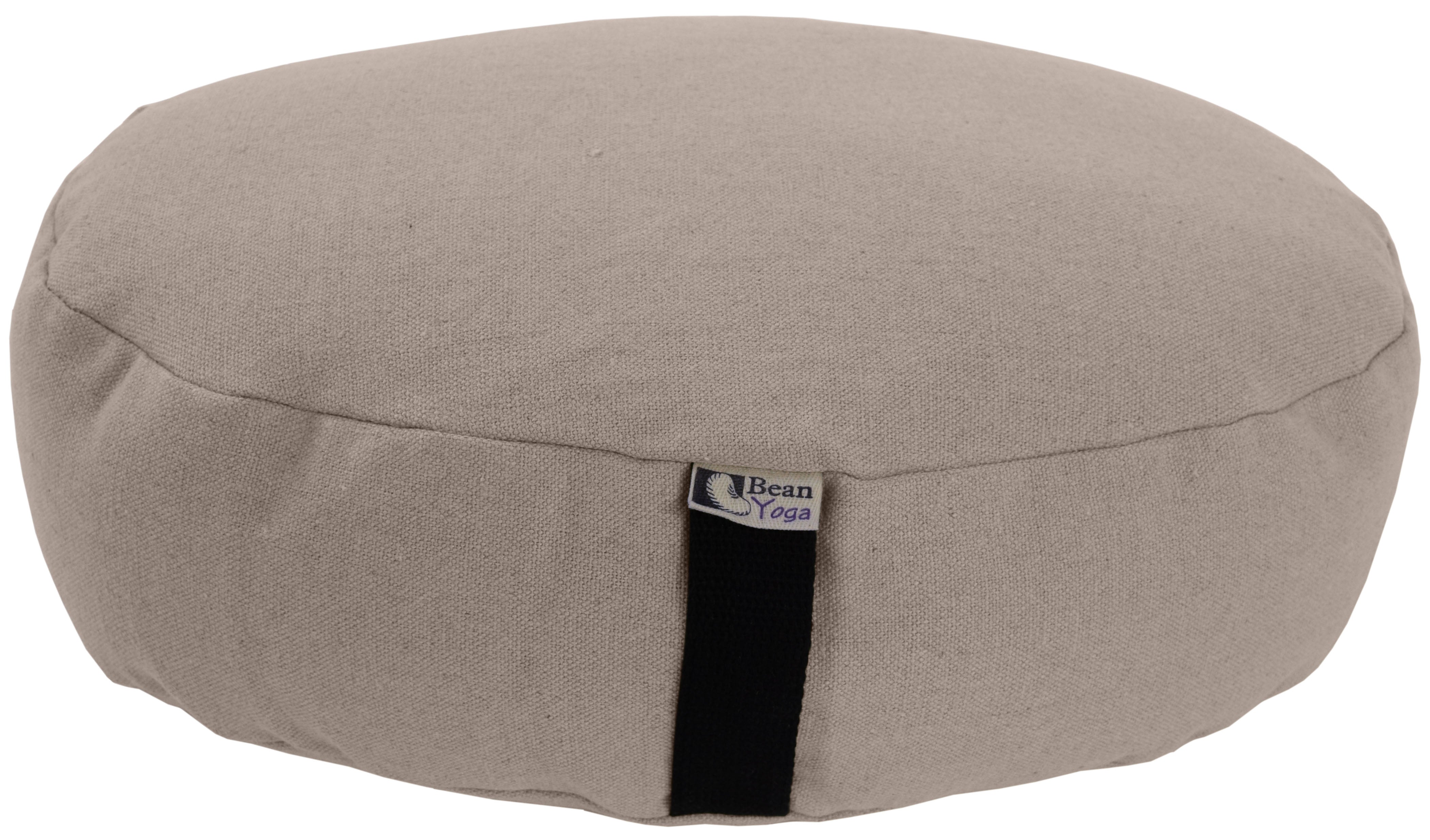 Beige meditation cushion with a visible brand tag on a white background