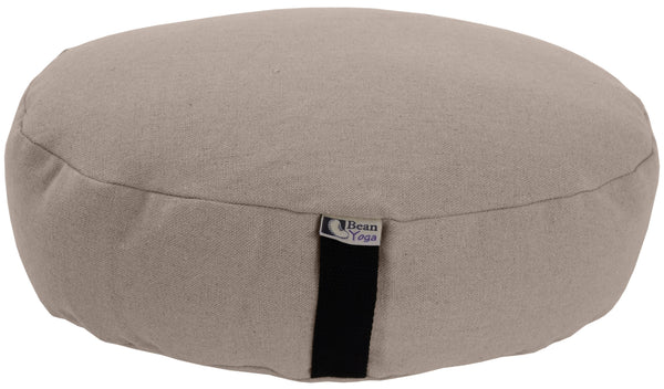 Beige meditation cushion with a visible brand tag on a white background