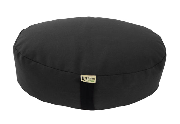 Black meditation cushion with a brand label on a white background