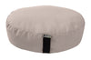 Beige meditation cushion with a black strap on a white background