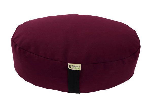 Maroon meditation cushion with a visible brand label on a white background
