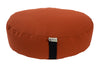 Orange meditation cushion with a black strap on a white background