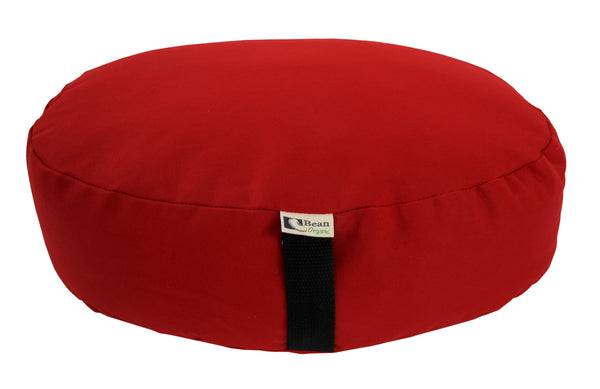Red meditation cushion with a black strap on a white background