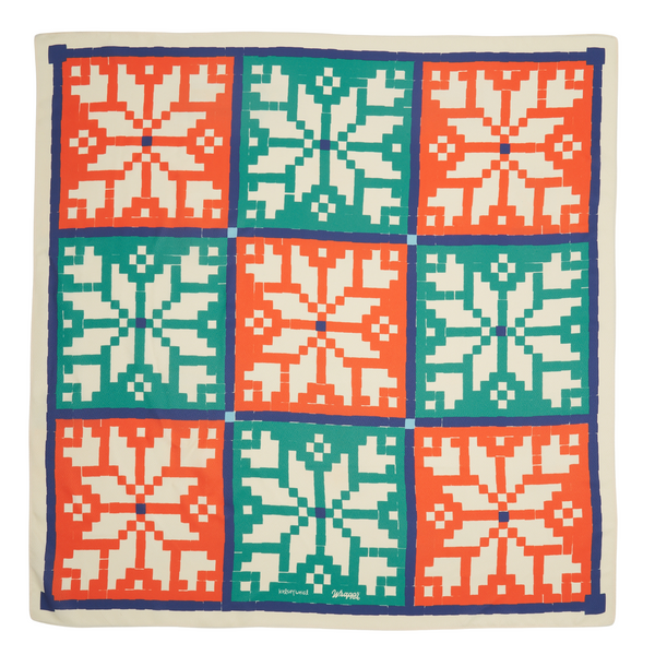 Kelsey Weigl Fair Isle furoshiki reusable gift wrap folded flat, showing bold geometric snowflake design in festive colours