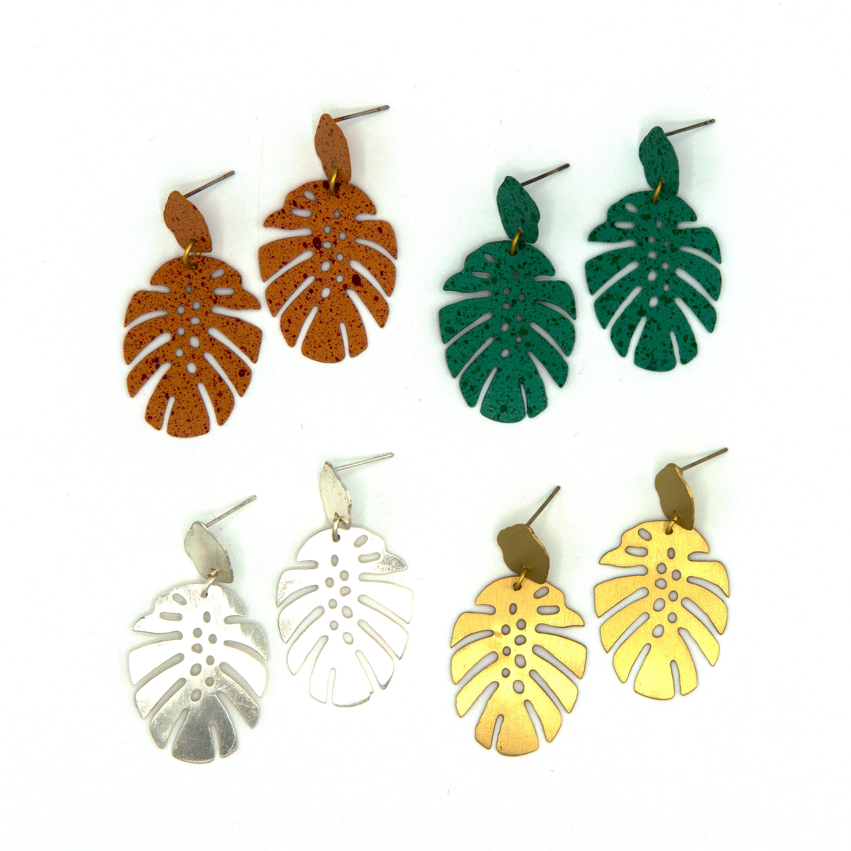 Fair Anita monstera leaf stud earrings in silver-plated recycled metal on a flat lay surface