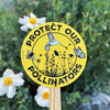 Round 9-inch embossed aluminium garden sign reading Protect Our Pollinators with bee, butterfly, and bird artwork, by Seattle Seed Company