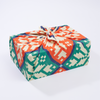 Fair Isle Collection furoshiki wrap by Kelsey Weigl styled around a wrapped gift with a tied knot finish