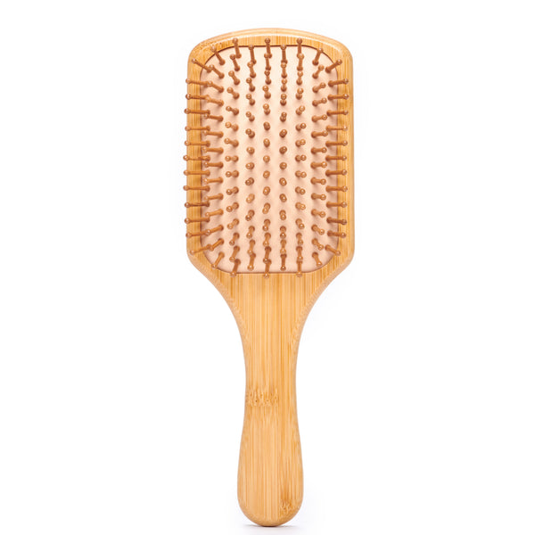 Desesh bamboo paddle hair brush with carbonized bamboo bristles and natural rubber padding on a light background