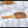 Close-up of Desesh eco-friendly bamboo paddle hair brush showing bristle detail and bamboo handle
