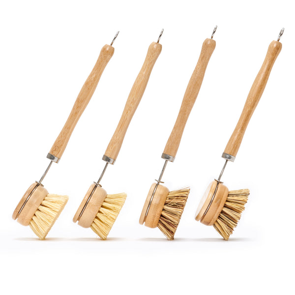Desesh long handle wood and metal dish brush with natural fiber bristles on a clean surface