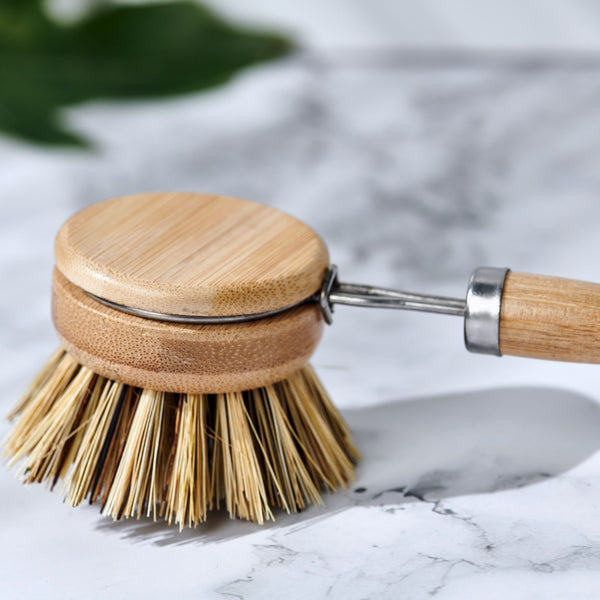Desesh long handle dish brush with sisal fiber bristles next to kitchen sink