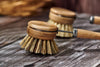 Desesh wood and metal dish brush displayed showing plastic-free eco-friendly packaging