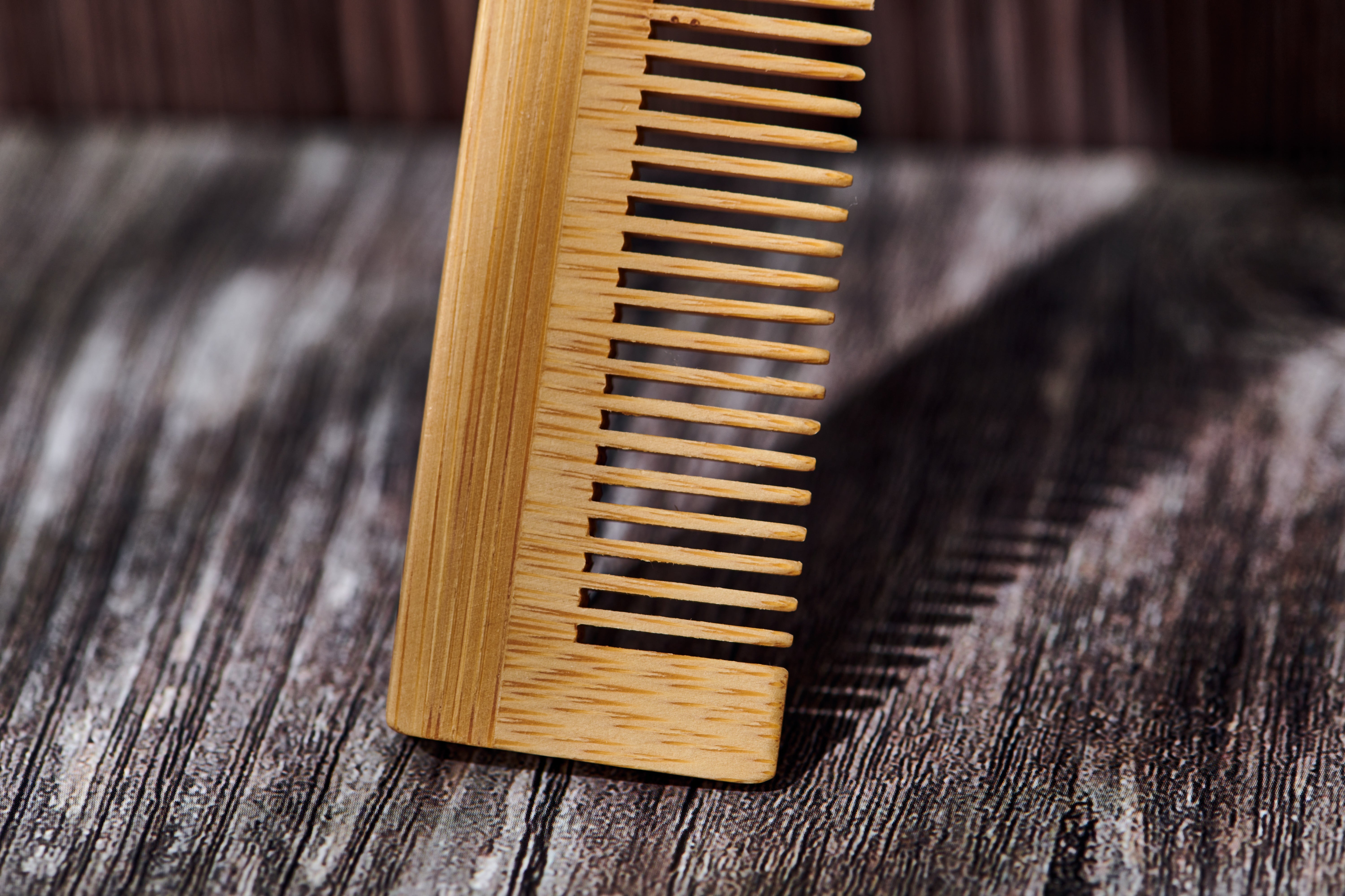 Desesh bamboo hair comb styled in a sustainable bathroom setting — unbranded minimal design