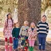 Baby wearing Mon Coeur hearts ruffle dress styled with leggings for cool weather