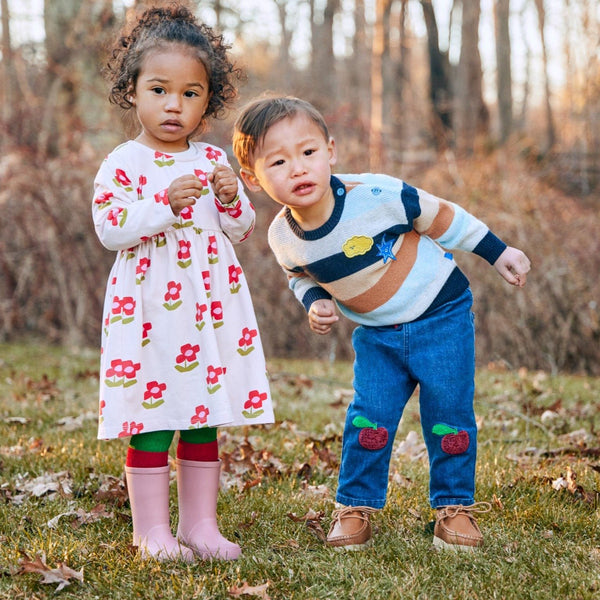 Baby wearing Mon Coeur organic cotton floral dress — lifestyle photo