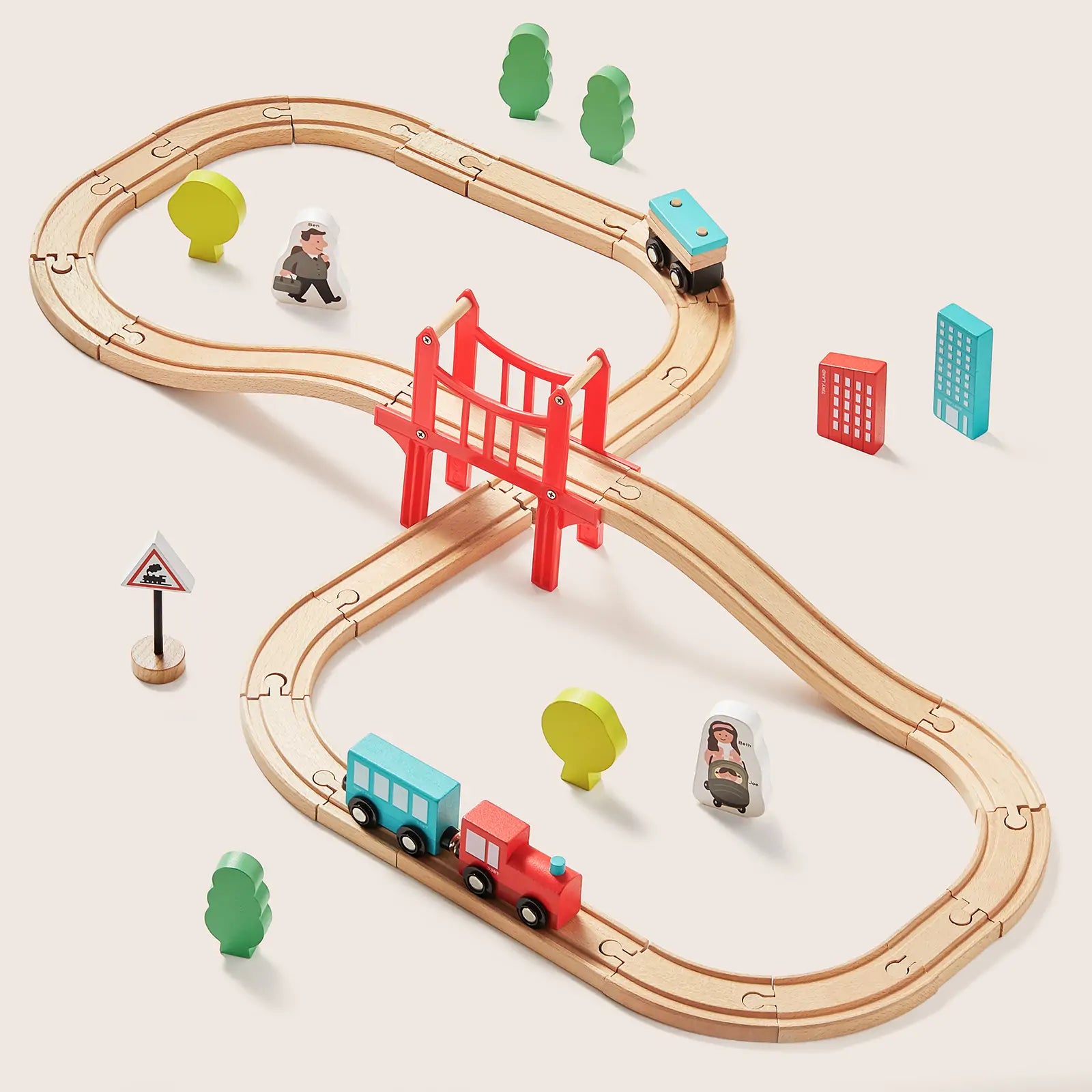 Wooden toy train track set with trains and accessories on a beige background