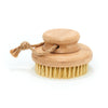 Desesh bamboo dry body brush with short handle and natural sisal bristles on a clean background