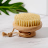 Top-down view of the Desesh bamboo dry body brush with natural sisal bristle surface