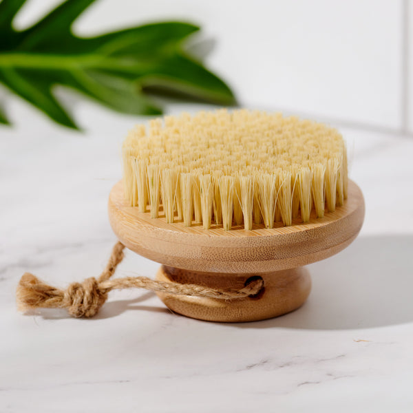 Top-down view of the Desesh bamboo dry body brush with natural sisal bristle surface