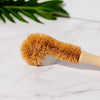 Desesh sustainable bamboo bottle brush laid flat showing full length and natural materials