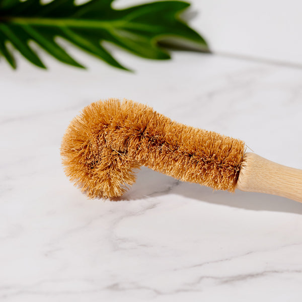 Desesh sustainable bamboo bottle brush laid flat showing full length and natural materials
