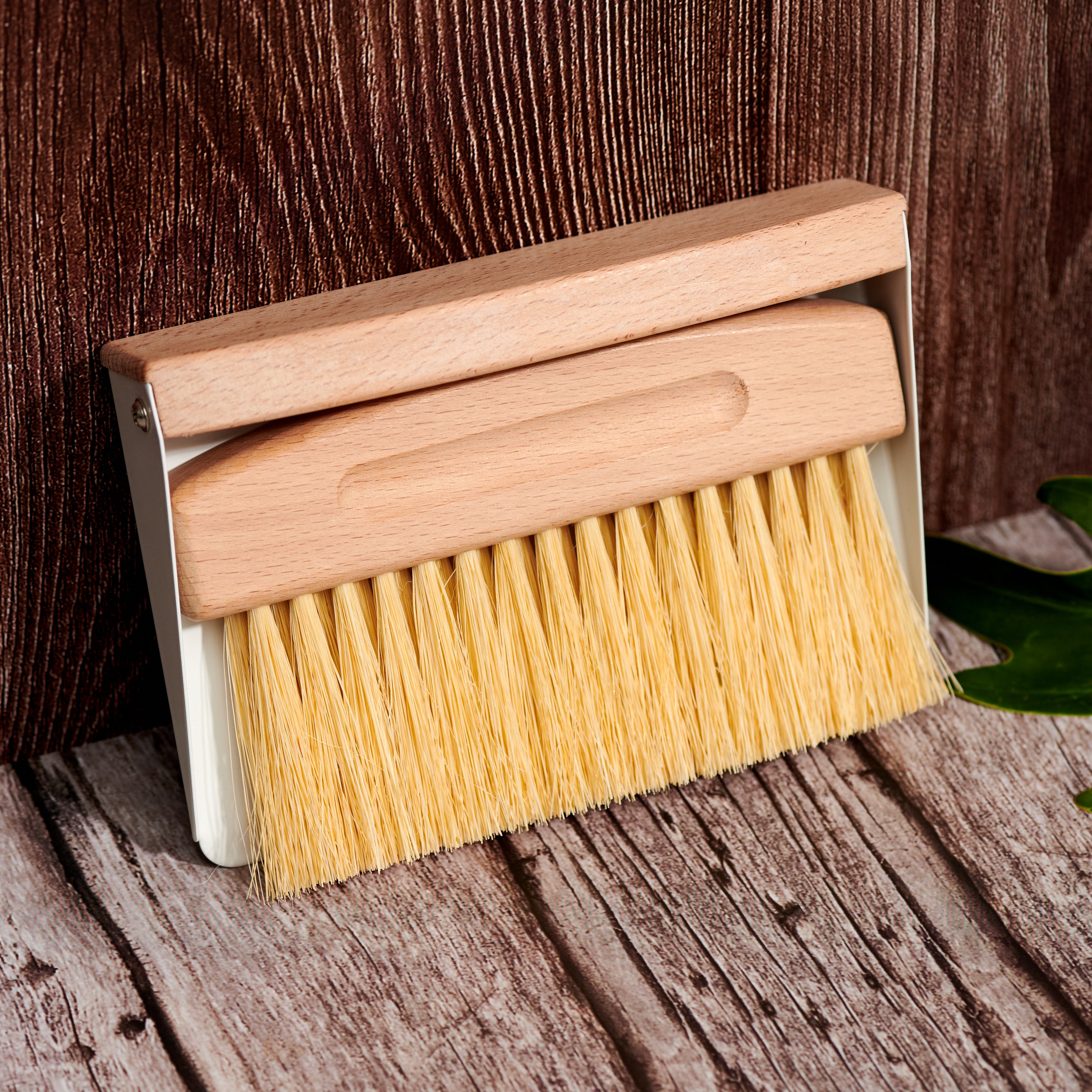 Wooden brush with yellow bristles on a wooden surface