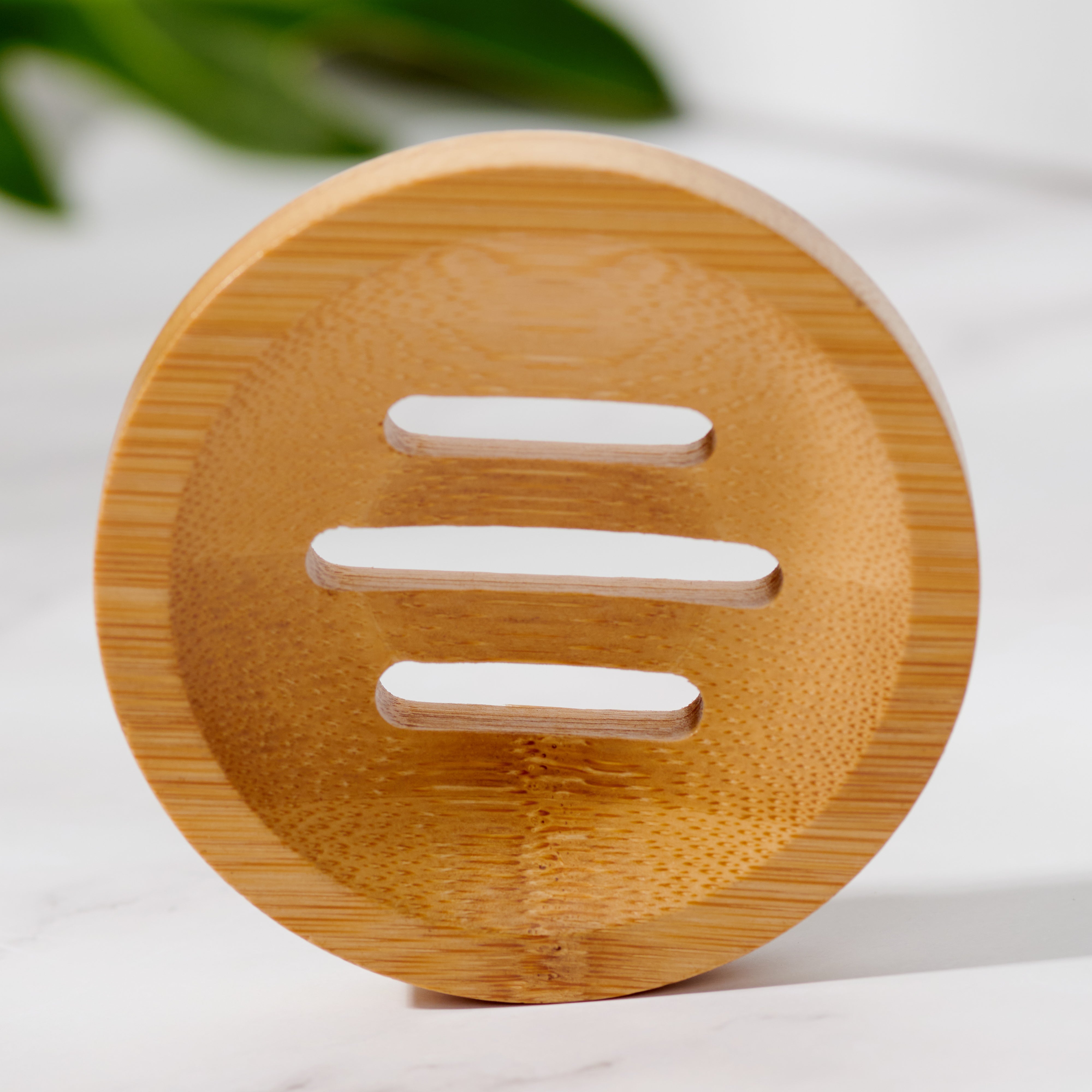 Close-up of natural bamboo circular soap dish showing slatted drainage detail