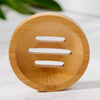 Close-up of natural bamboo circular soap dish showing slatted drainage detail