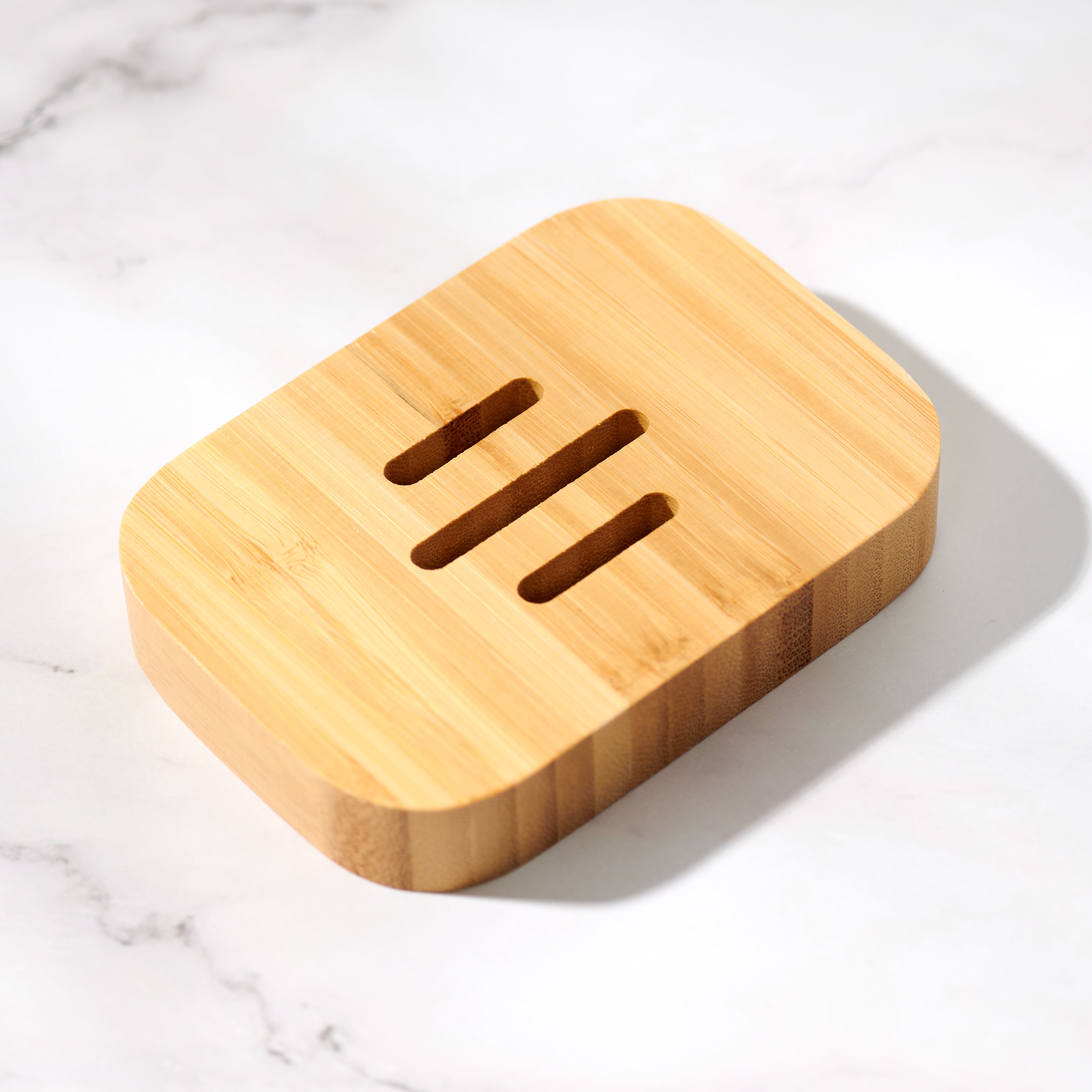 Top-down view of curved rectangular bamboo soap dish showing open drainage slats