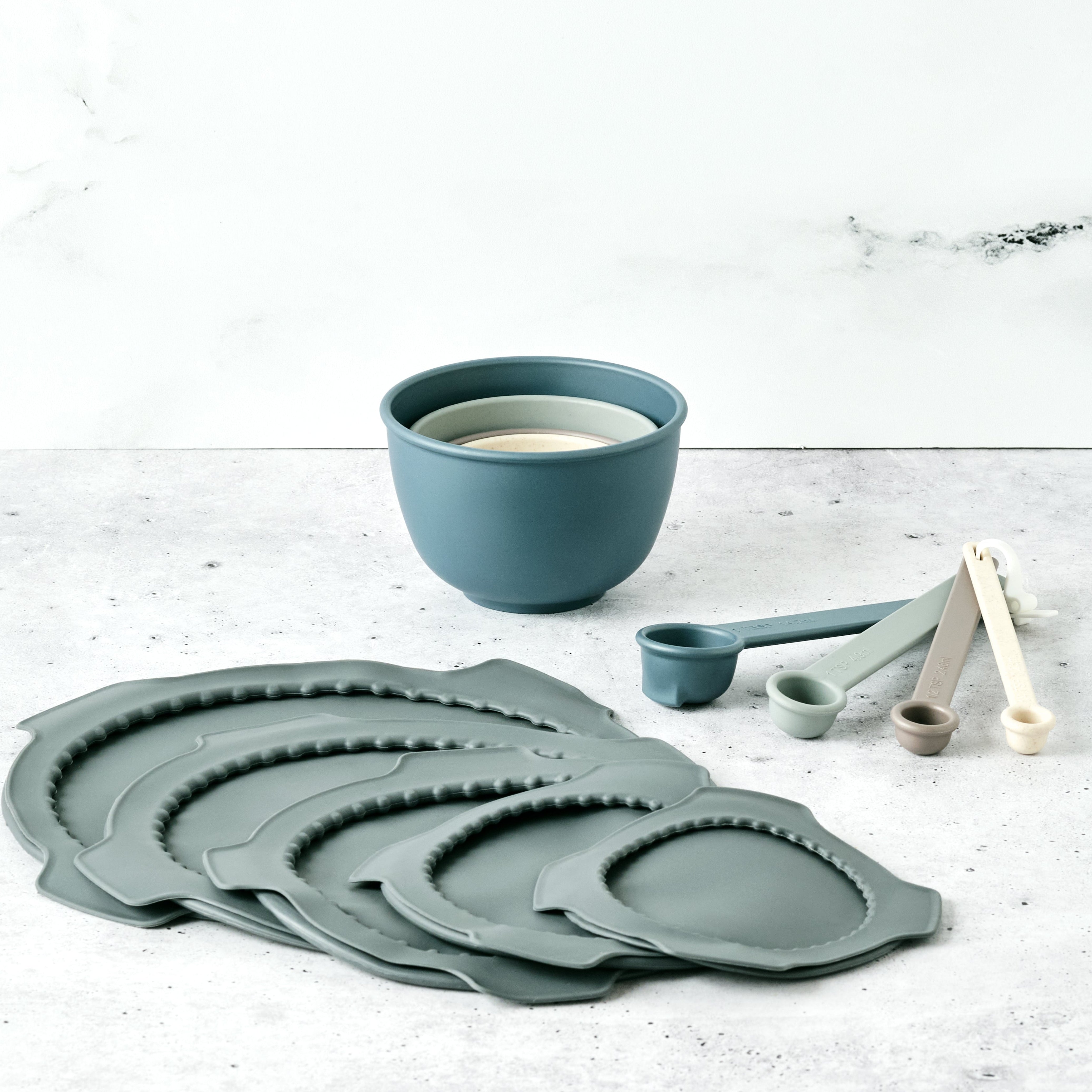 Bamboozle mixing bowl lids and measuring tool bundle laid out on a kitchen surface