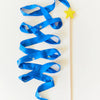 Blue ribbon on a stick with a yellow star against a white background