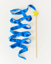 Blue ribbon on a stick with a yellow star against a white background