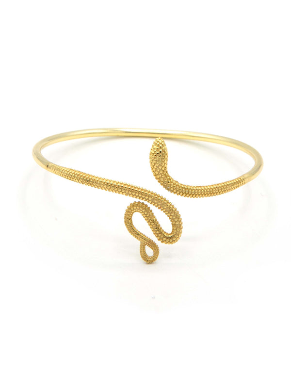 Flat lay of viper snake cuff bracelets in brass and silver finishes, fair trade jewellery by Fair Anita