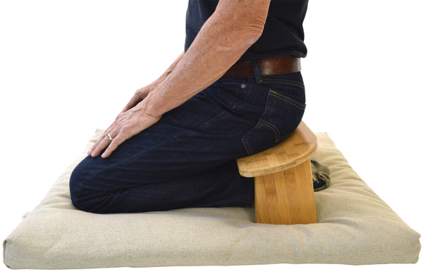 Person using Bean Products zabuton meditation base cushion during a seated meditation session