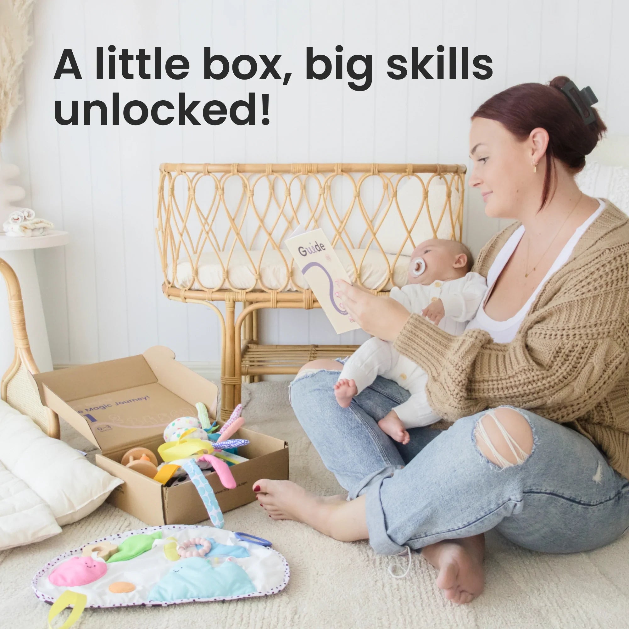 Woman holding a baby with toys and a box in a nursery setting, text 'A little box, big skills unlocked!'.