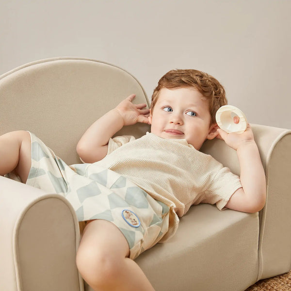 Tiny Land kids sofa chair unfolded flat into a children's lounge bed in beige white